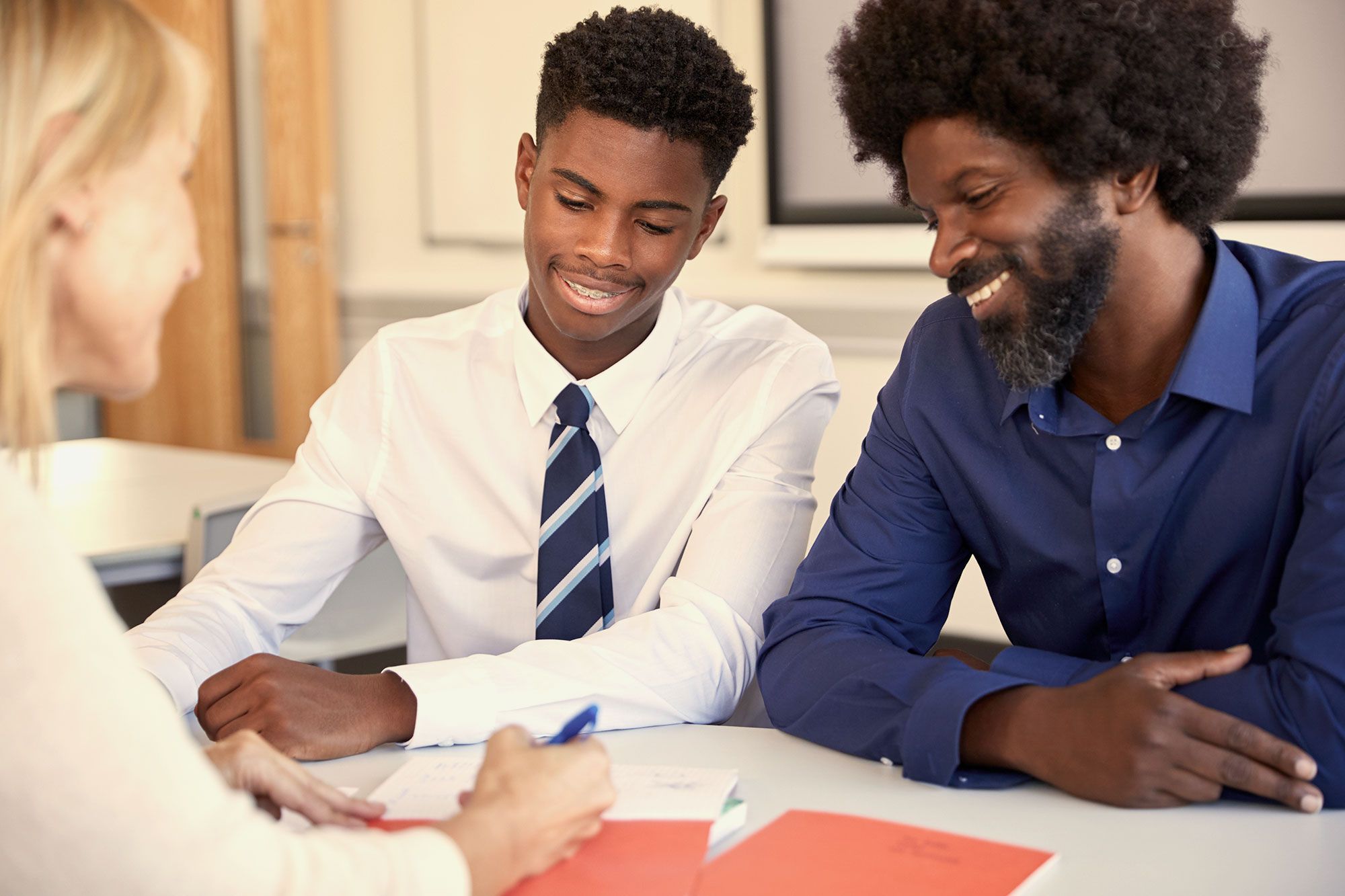 Parents and student discussing college options with an advisor
